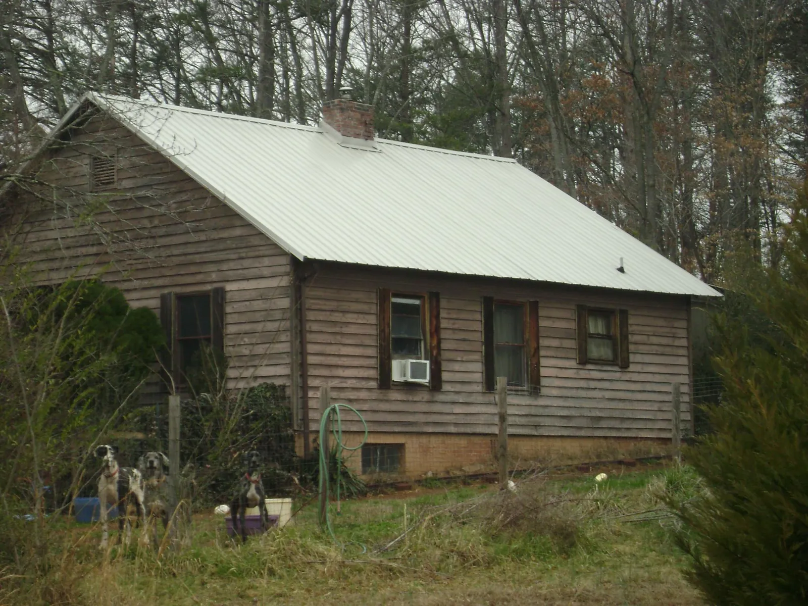 White metal roof on an old wood sided farmhouse, from a Metal Roof Installation job in Ashtabula